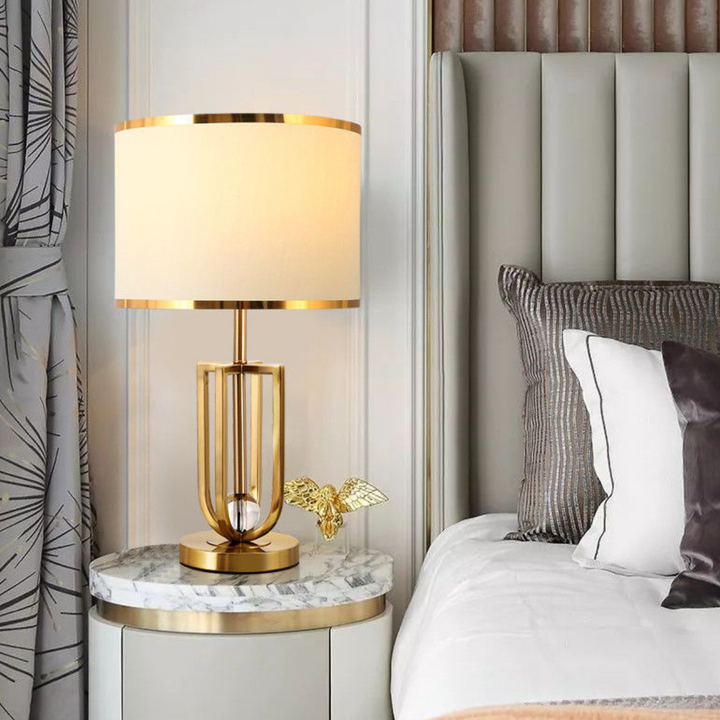 Amanda metal-based modern table lamp placed beside bed in stylish bedroom