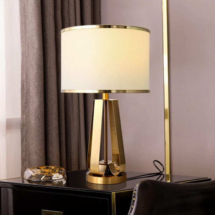 Aura metal-based bedside table lamp beside table, sleek modern design with warm ambient lighting