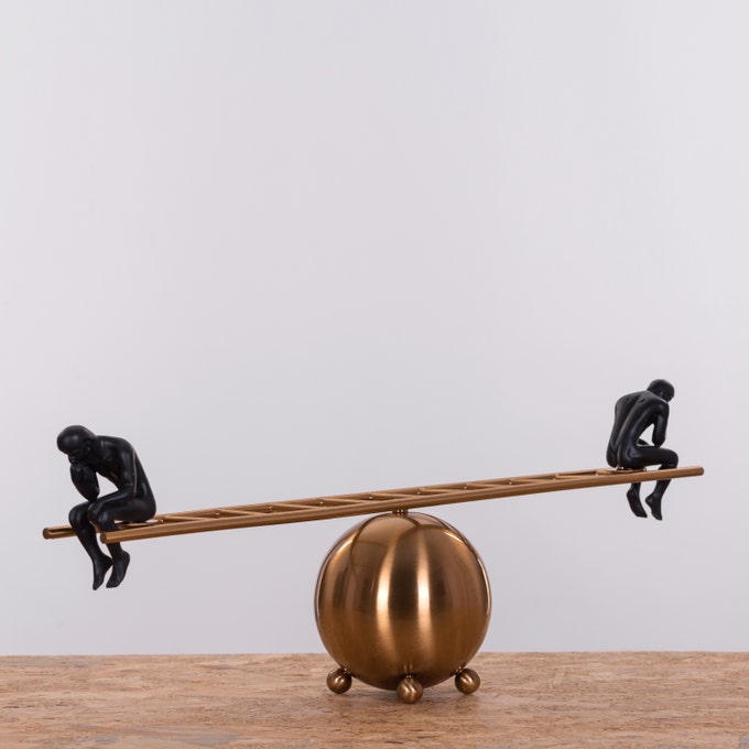 Black thinker statues pair on ladder, modern decor