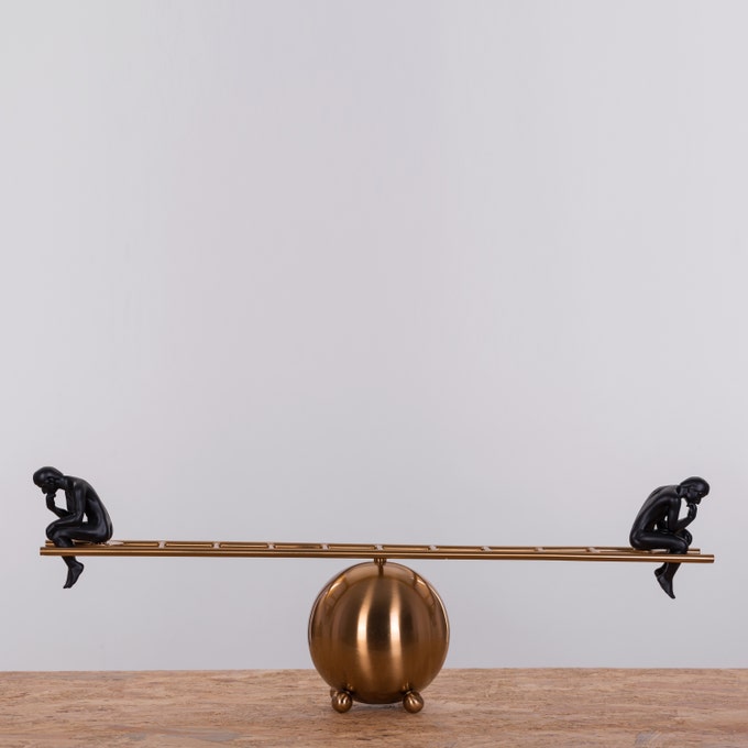 Black thinker statues pair on decorative ladder