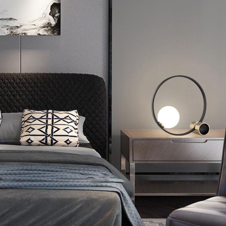 Bozza circle-shaped bedside table lamp, modern sleek design adding warm ambient lighting to bedrooms