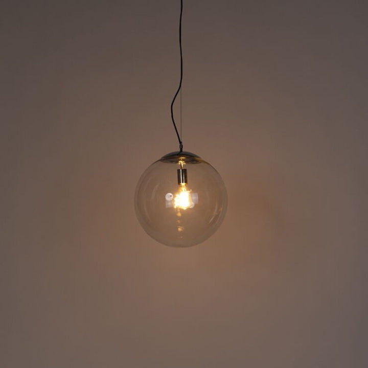 Single light pendant turned on, casting warm ambient light in a stylish interior setting