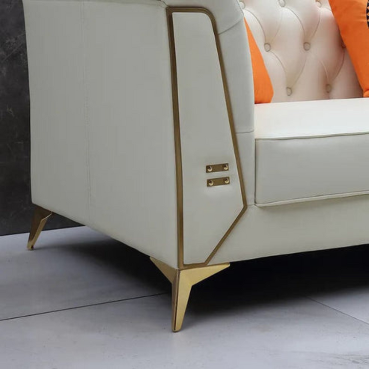 Detailed shot of Chesterfield two-seater sofa’s side with elegant metal trim