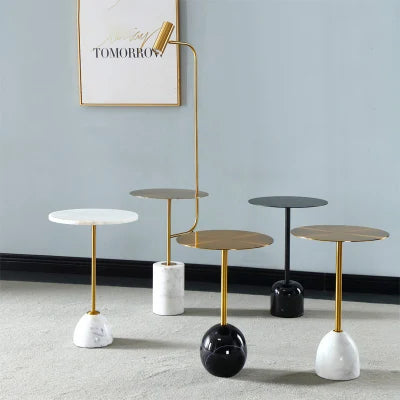 Small round marble coffee table designed for balcony or living room, featuring polished stone top and sleek stainless steel legs