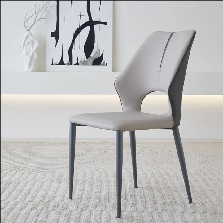  Side view of Cora Dining Chair Y70 in an elegant Australian interior – featuring smooth curves, upholstered seat, and minimalist modern design