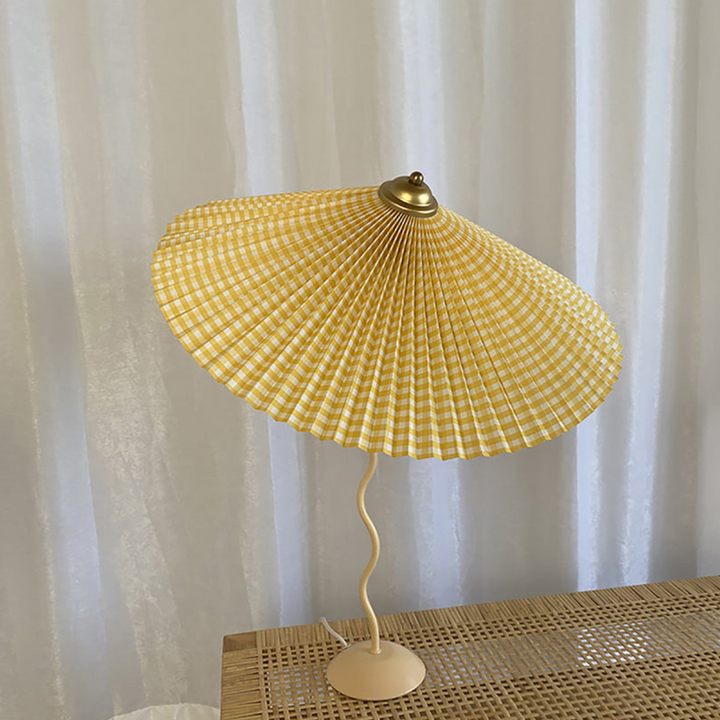 Modern table lamp featuring unique folded fabric shade