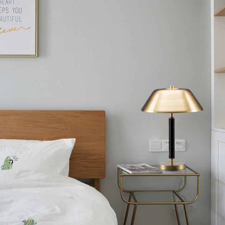 Minimalist Franklin table lamp on nightstand next to cozy bed