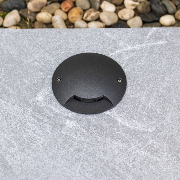 5W garden inground LED light placed on ground – outdoor landscape lighting showcasing compact design and durable build.