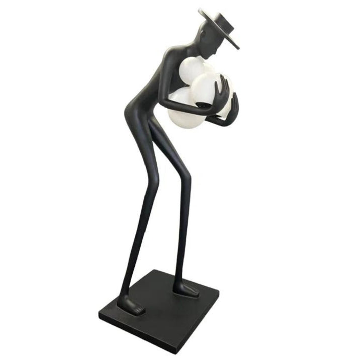 Black human sculpture floor lamp holding glowing orbs, showcasing modern artistic design and lighting