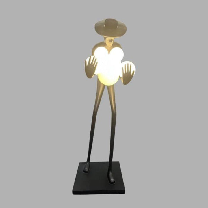 Front view of black human sculpture floor lamp with glowing orbs, illuminated and modern artistic design
