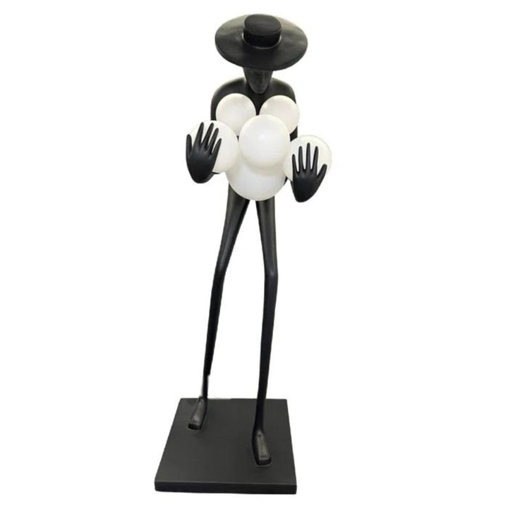 Front view of black human sculpture floor lamp with glowing orbs, combining modern art and lighting