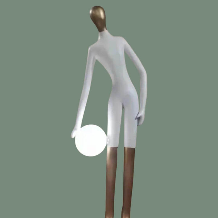 White statue floor lamp holding illuminated light globe, combining artistic sculpture with warm lighting