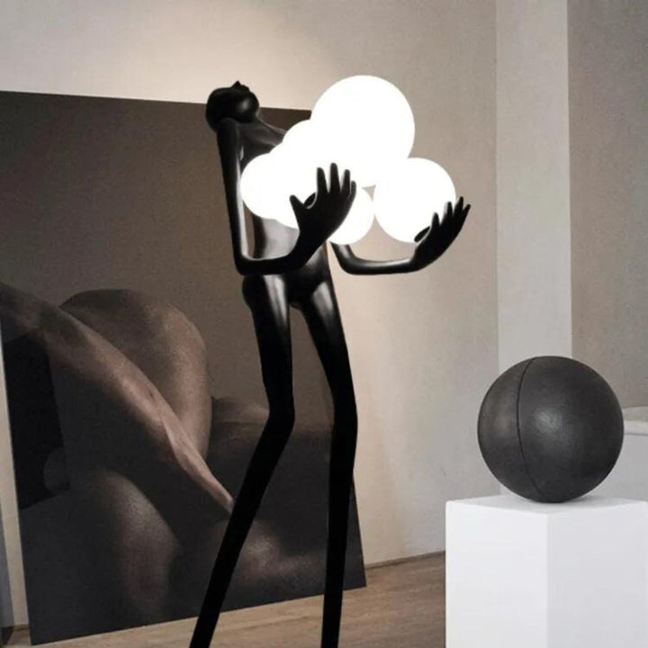Close-up view of HTA001 humanoid floor lamp turned on, highlighting detailed design and warm light