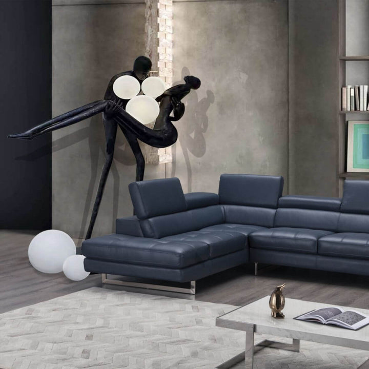 HTA018 artistic floor lamp with man holding woman sculpture, placed in a stylish Australian living room, blending modern art and warm ambient lighting