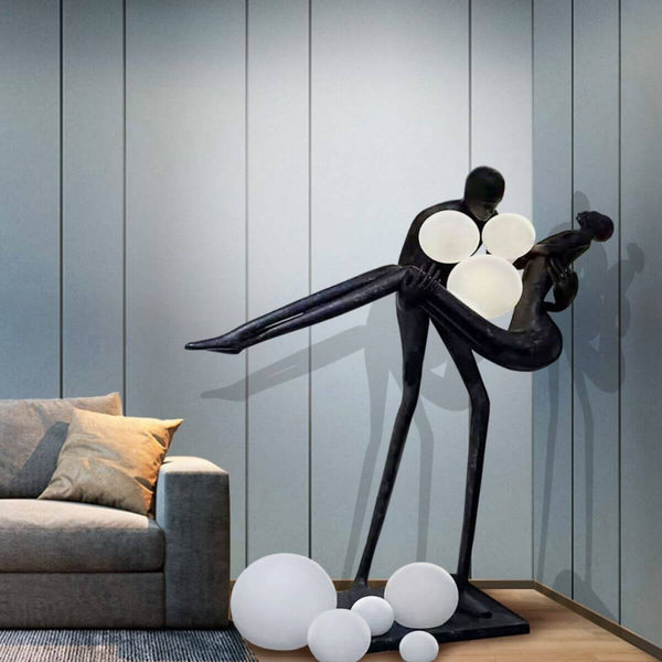 HTA018 artistic floor lamp depicting a man holding a woman, displayed in an Australian interior, blending sculptural form with ambient lighting
