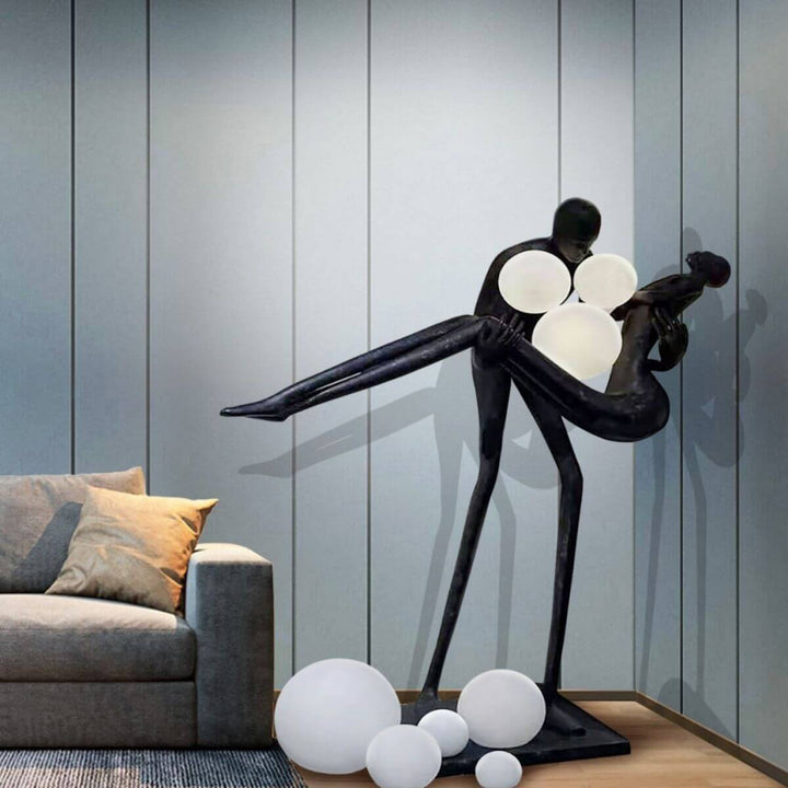 HTA018 artistic floor lamp depicting a man holding a woman, displayed in an Australian interior, blending sculptural form with ambient lighting