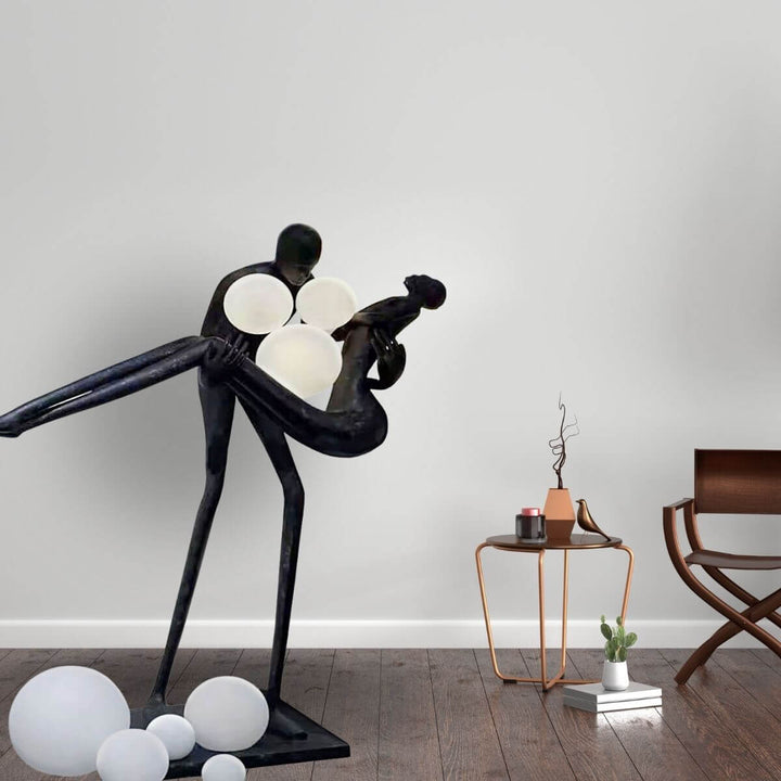 HTA018 artistic floor lamp featuring a man holding a woman sculpture, showcased in an elegant Australian interior with warm ambient lighting