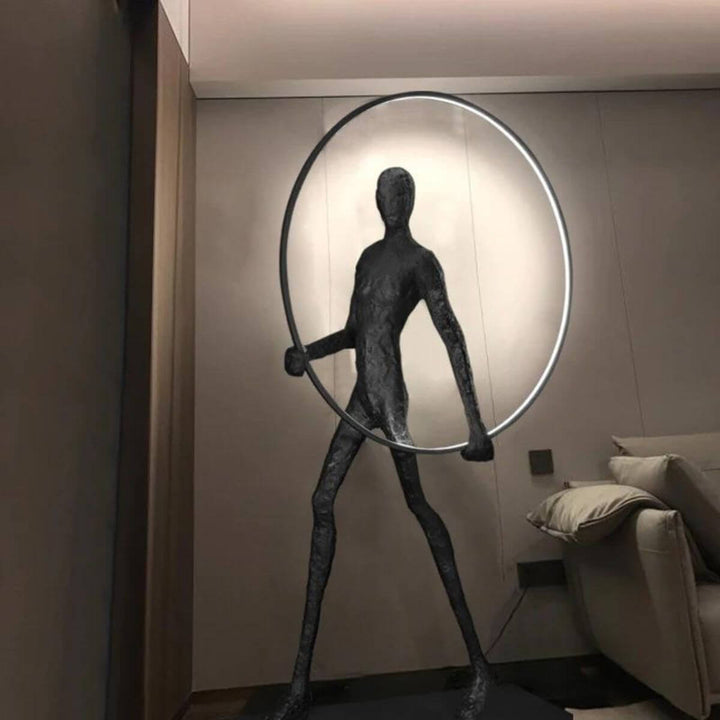 HTA019 man walking with circle floor lamp in Australian living room, highlighting modern ambient lighting
