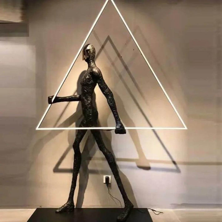Human statue floor lamp featuring a geometric triangle design, combining modern sculpture with ambient lighting for contemporary interiors