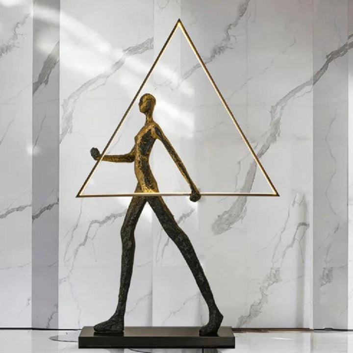 Side view of human statue floor lamp with triangle design, showcasing modern sculptural aesthetics and soft ambient lighting