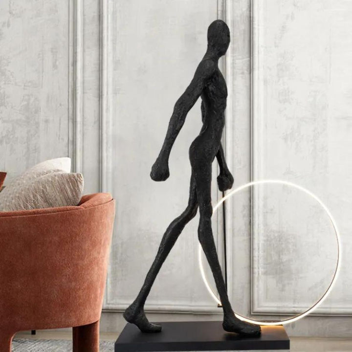 Man walking beside a circle LED floor lamp in a modern living room, showcasing sleek lighting design and warm ambient glow