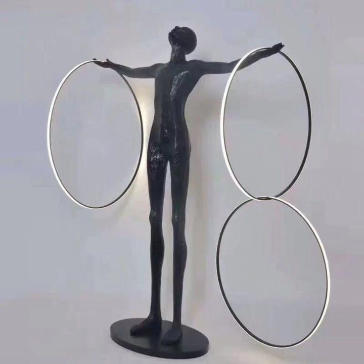 Angled view of a human posing next to a burning circle LED floor lamp, showcasing the lamp’s glowing ring design and modern ambient lighting