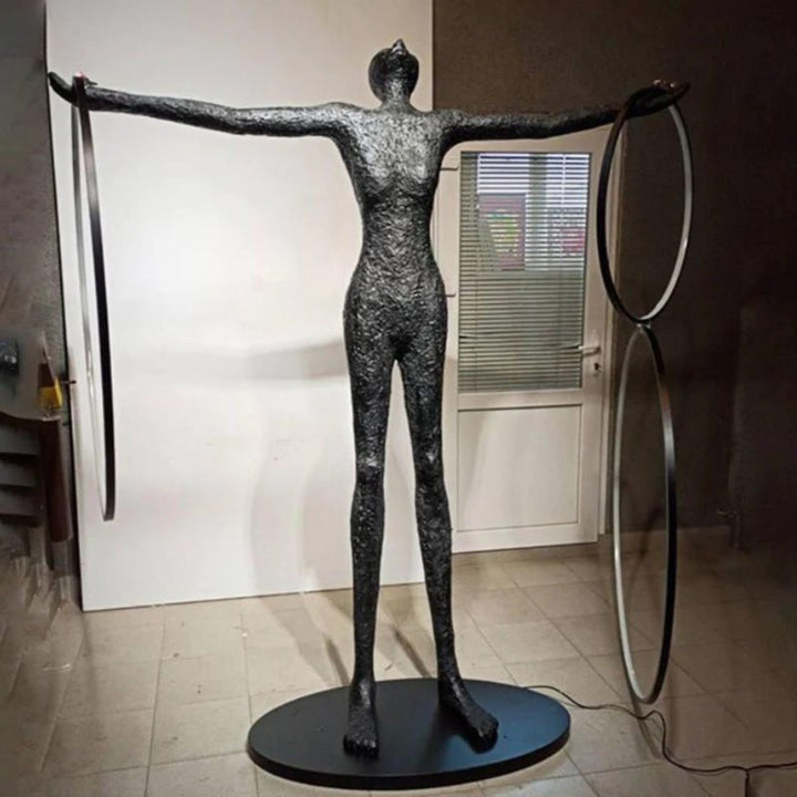 Human posing beside a burning circle LED floor lamp, featuring a glowing circular frame and modern ambient lighting design