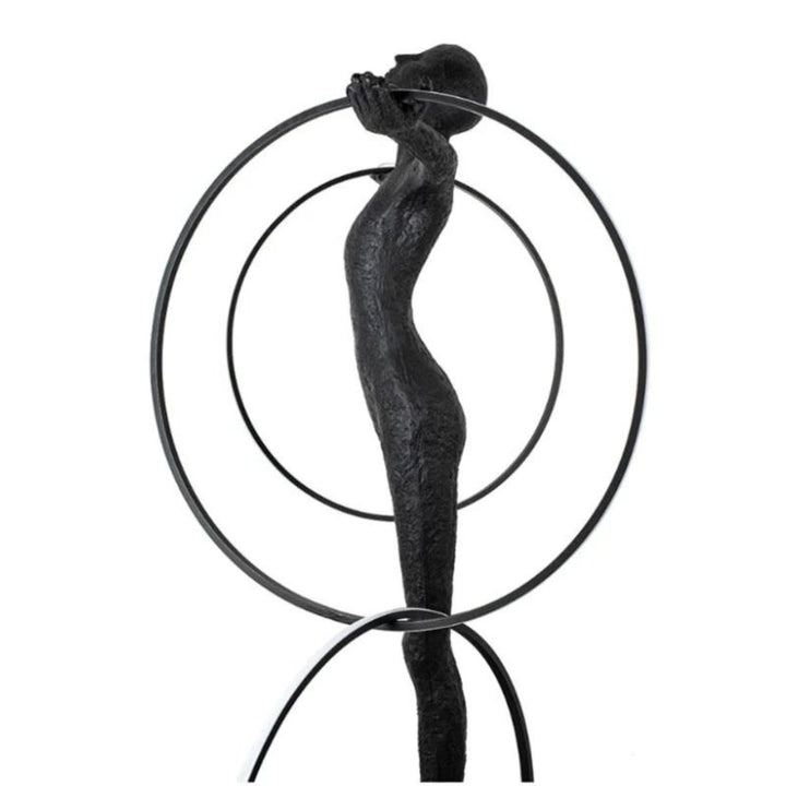 Side view of a person posing beside a burning circle LED floor lamp, showcasing its sleek circular frame and warm ambient lighting in a modern setting