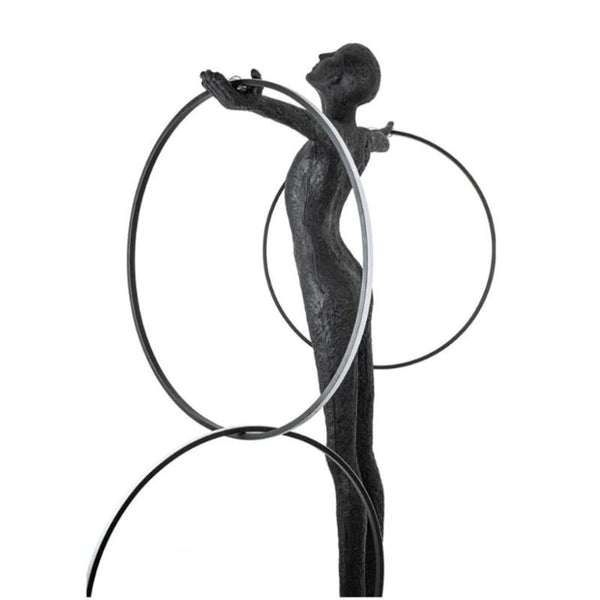 Side view of a human posing next to a burning circle LED floor lamp, showcasing modern design and warm ambient lighting