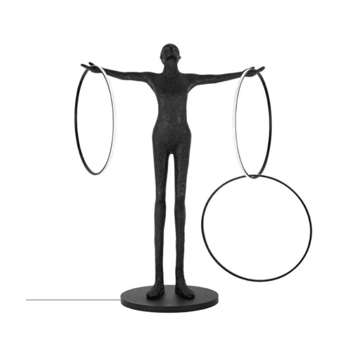 Front view of a human posing beside a burning circle LED floor lamp, highlighting the lamp’s circular glow and modern aesthetic