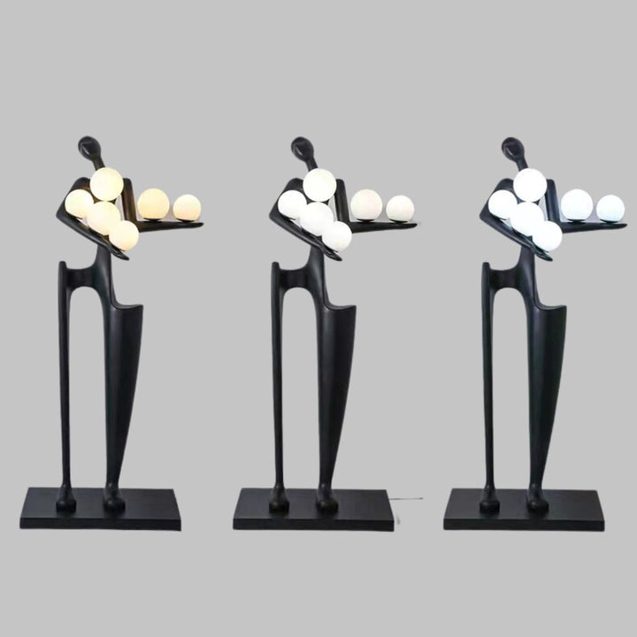 Dreamer black statue sculpture holding multiple glass globes, combining modern art with elegant ambient lighting