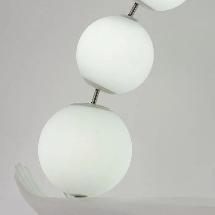 Close-up view of HTA050 floor lamp’s woman holding lamps sculpture, highlighting lamp details and design