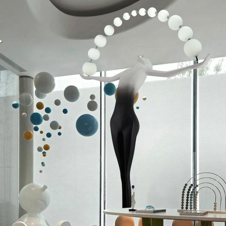 HTA050 floor lamp with woman holding lamps sculpture, combining artistic design and ambient lighting