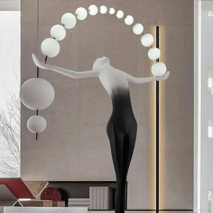 HTA050 floor lamp with woman holding lamps sculpture in living room, blending art and warm lighting