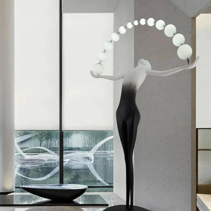HTA050 floor lamp featuring woman holding lamps sculpture, displayed in a modern Australian interior