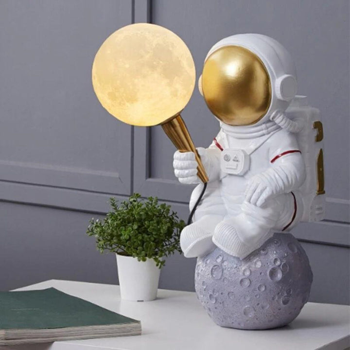 HTQ007 sitting astronaut table lamp turned on, emitting soft ambient light with futuristic design