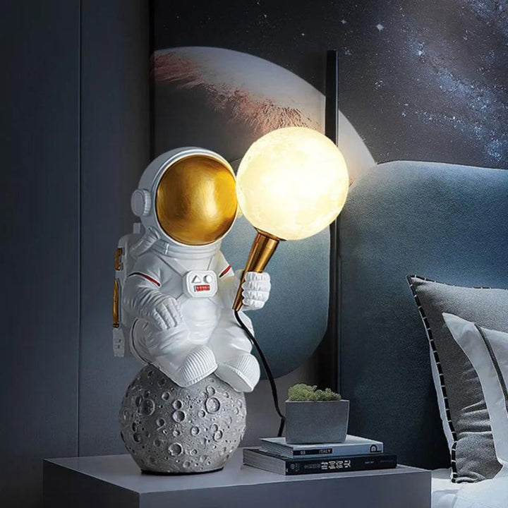 HTQ007 sitting astronaut table lamp placed beside bed, adding futuristic charm to bedroom decor