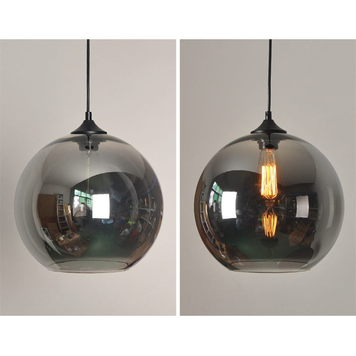Hugo single pendant light turned on, illuminating a modern interior space with warm ambient lighting