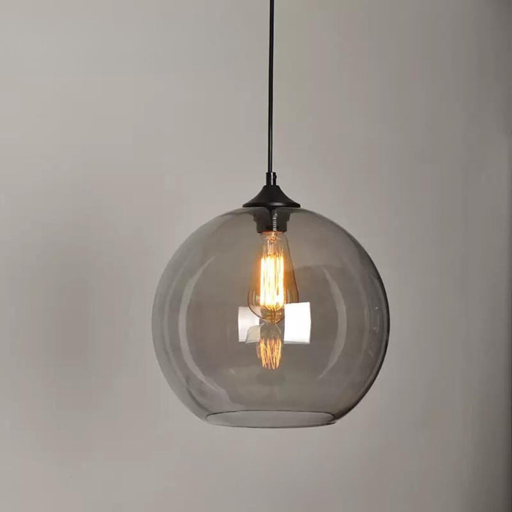 Hugo single pendant light glowing warmly in a contemporary interior, providing stylish and focused illumination