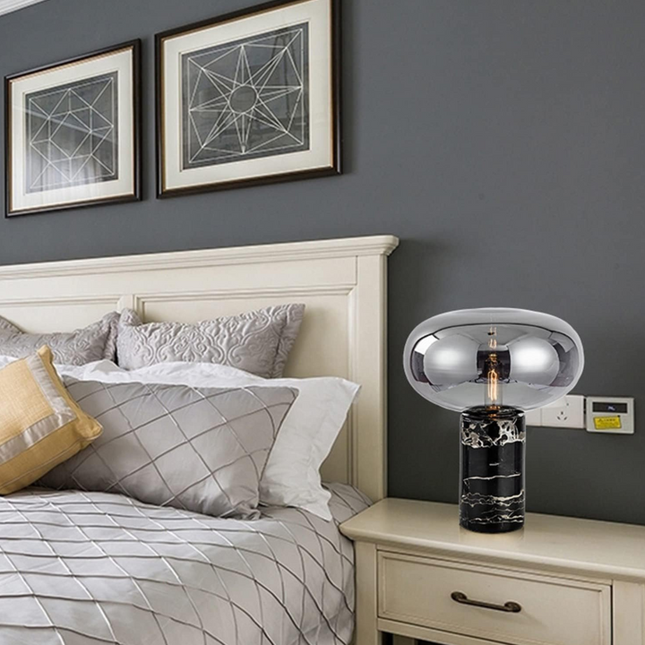 Kiara oval-shaped marble-based table lamp placed beside bed in modern bedroom