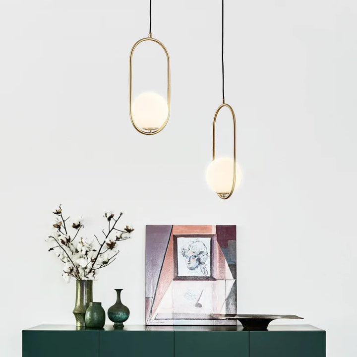 Klay Round Glass Suspended Light – elegant pendant light hanging above table, featuring clear glass globe and contemporary design.