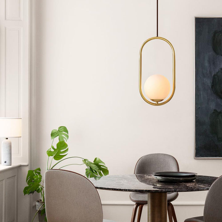 Klay Round Glass Suspended Light – elegant pendant light above dining table featuring clear glass globe and modern minimalist design.