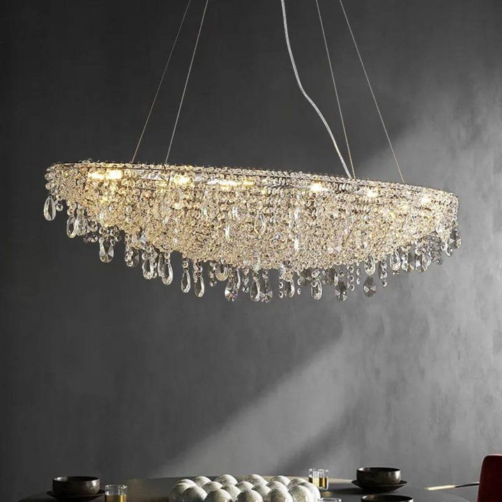 Zodiac crystal chandelier light hanging above dining table, enhancing elegant and sophisticated dining space
