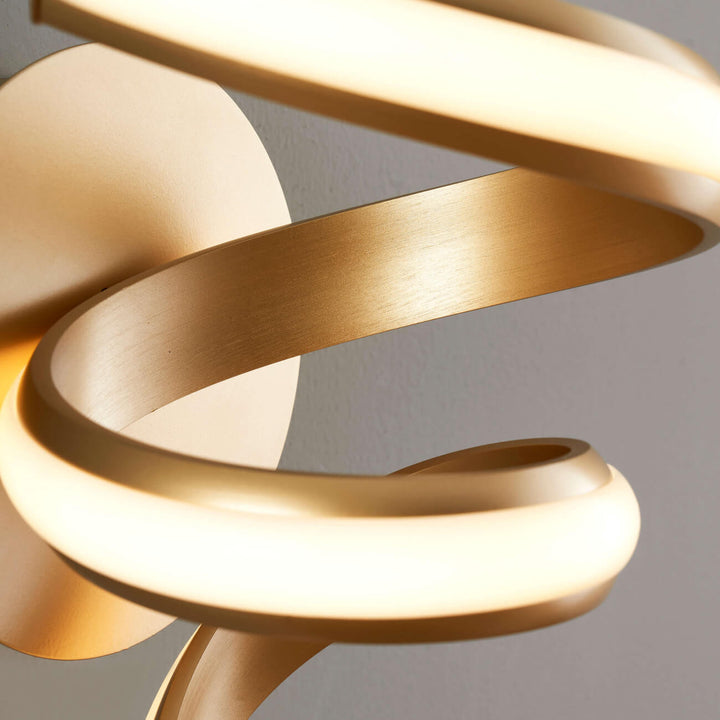 Close-up detail of Lara gold spiral LED wall light in elegant interior by Lux Decor Australia