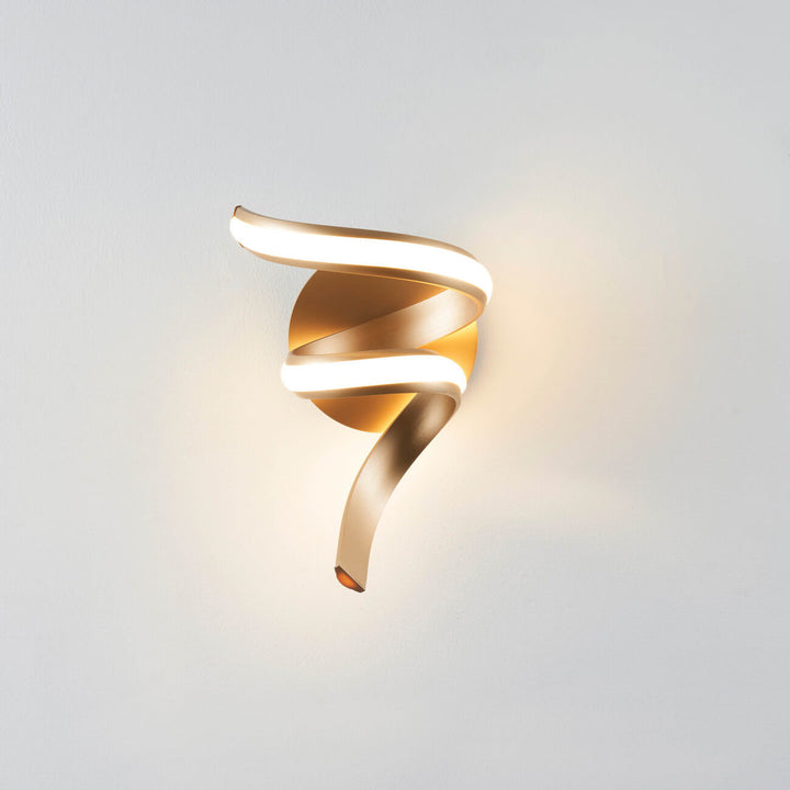 Front view of Lara gold spiral LED wall light turned on in elegant interior by Lux Decor Australia