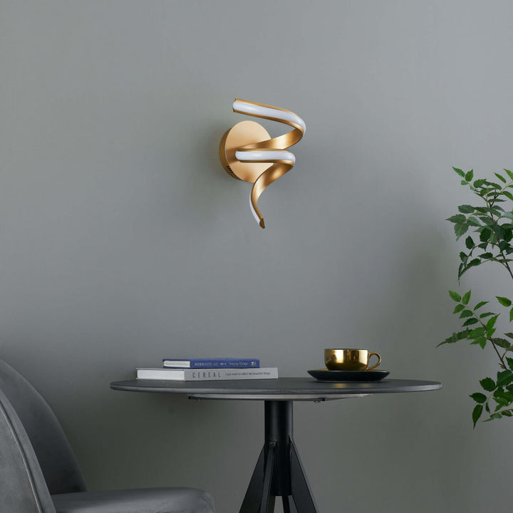 Side view of Lara gold spiral LED wall light in elegant interior setting by Lux Decor Australia