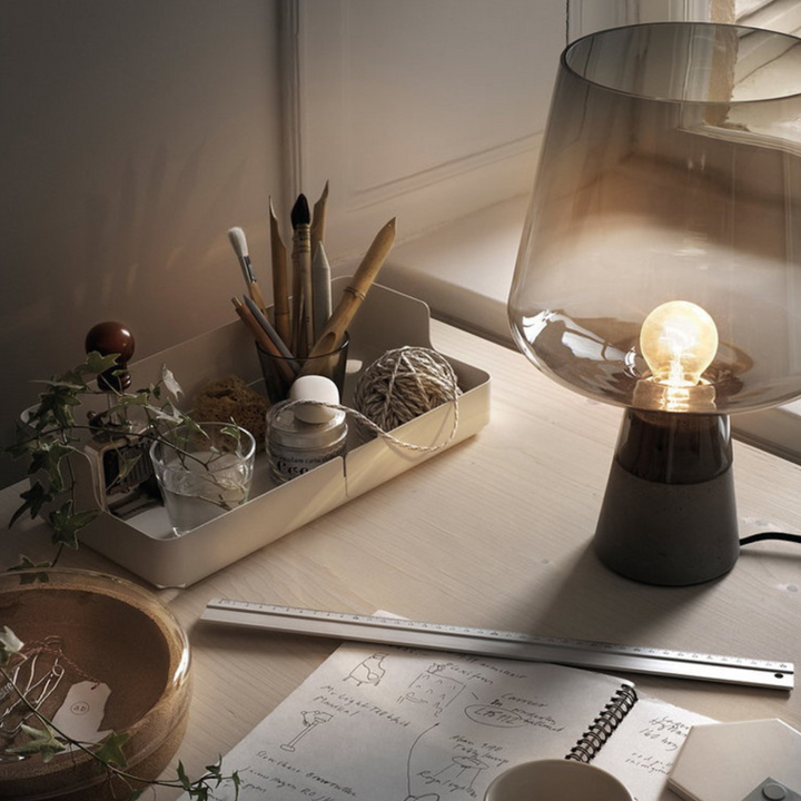 Leyman glass table lamp placed on reading table for focused illumination