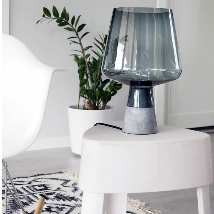 Leyman glass table lamp placed on side table in modern living room