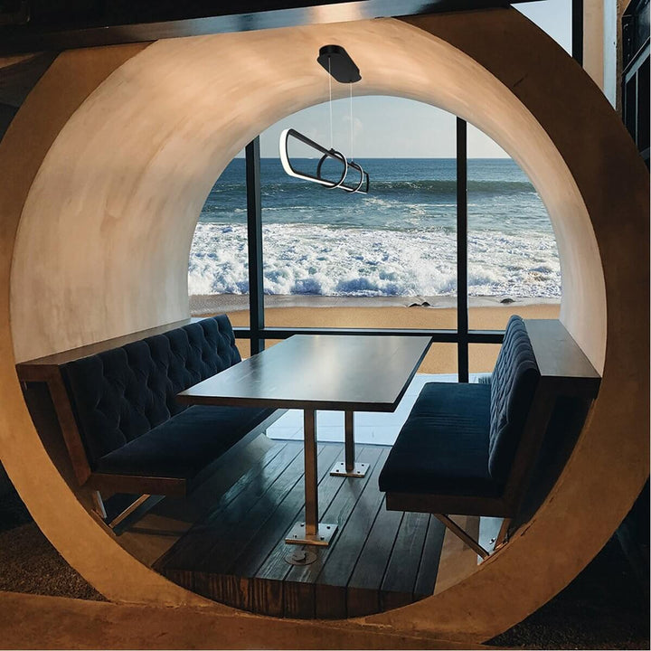 Luminex LED bar pendant light installed in a modern restaurant setting, providing sleek, linear illumination for a stylish dining atmosphere