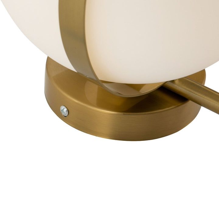 Close-up detail of modern gold round wall mount lamp showcasing polished finish and sleek design elements